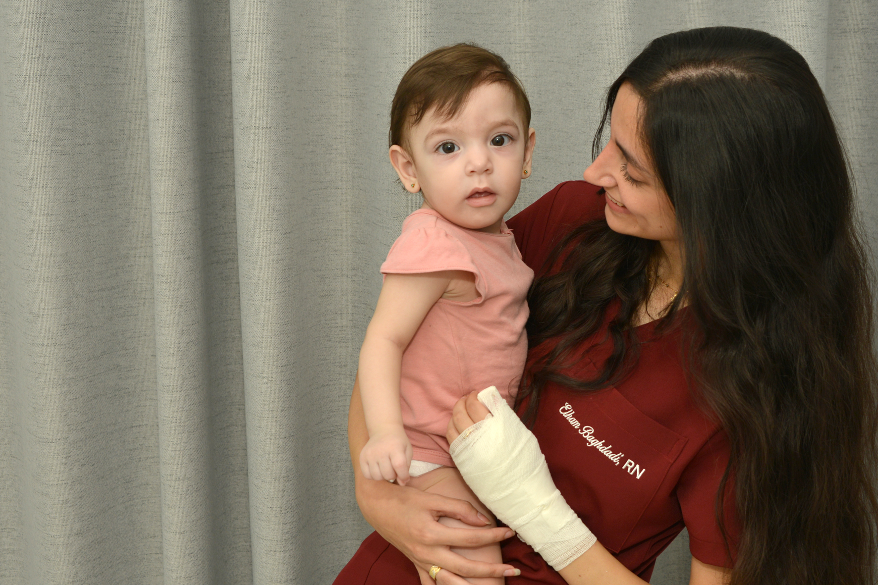 Mother holding a baby at a medical center